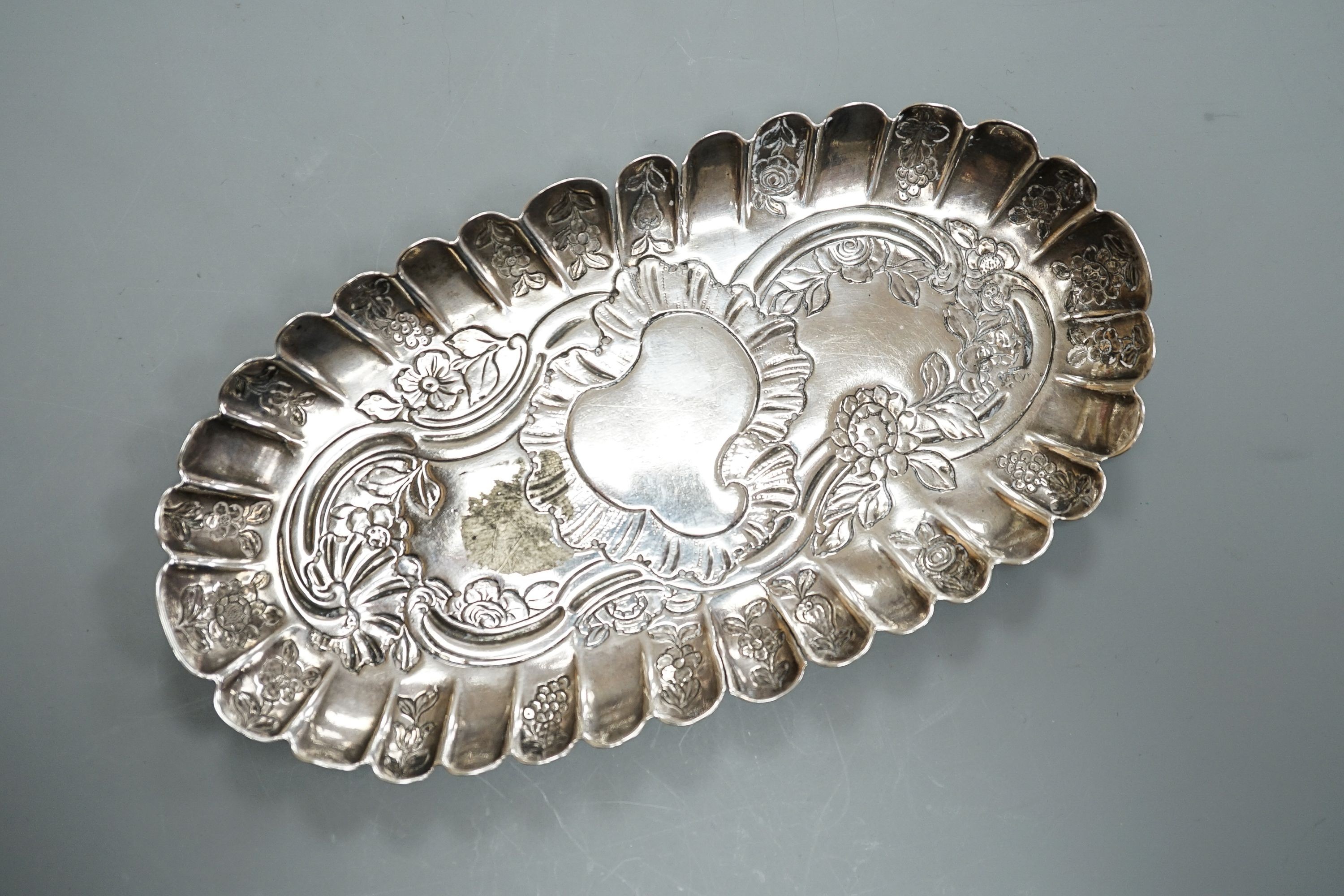 A mid 18th century Irish embossed silver oval pin tray, with engraved date and initials, maker ID?, Dublin, circa 1750, 16.4cm, 74 grams (a.f.)
